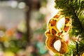 Beautiful carnival mask hanging on the Christmas tree in the background of bright Christmass decorations Royalty Free Stock Photo