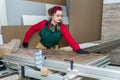 Beautiful carpenter making measurements of wooden plank Royalty Free Stock Photo