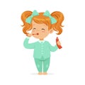 Beautiful cartoon redhead girl in a light blue pajamas brushing her teeth, kids dental care vector Illustration