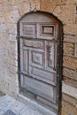 Beautiful carved wooden door in the stone wall of  very ancient stone building in the Old City of Jaffa in Israel Royalty Free Stock Photo