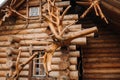 Beautiful carved wooden house in the village of logs and farmyards