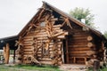 Beautiful carved wooden house in the village of logs and farmyards