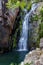 Beautiful cascade of Veu da Noiva between the covered stones of moss and the vegetation