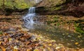 Colorful majestic waterfall in national park forest during autumn Royalty Free Stock Photo