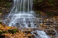 Colorful majestic waterfall in national park forest during autumn Royalty Free Stock Photo