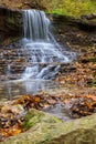 Colorful majestic waterfall in national park forest during autumn Royalty Free Stock Photo