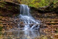 Colorful majestic waterfall in national park forest during autumn Royalty Free Stock Photo