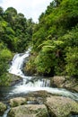 Beautiful cascade waterfall hidden in a forest. Adventure and travel concept. Nature background. Kaiate Falls, Bay of Royalty Free Stock Photo