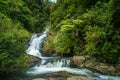 Beautiful cascade waterfall hidden in a forest. Adventure and travel concept. Nature background. Kaiate Falls, Bay of Royalty Free Stock Photo