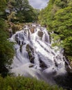 Beautiful cascading waterfall through a lush green landscape - Swallow Falls in Betws y Coed, North Wales Royalty Free Stock Photo