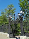 Beautiful cast-iron gates with lanterns and a lattice with decorations at the entrance to the Summer Garden of the city of Royalty Free Stock Photo