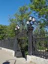 Beautiful cast-iron gates with lanterns and a lattice with decorations at the entrance to the Summer Garden of the city of Royalty Free Stock Photo