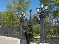 Beautiful cast-iron gates with lanterns and a lattice with decorations at the entrance to the Summer Garden of the city of Royalty Free Stock Photo