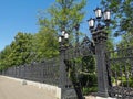 Beautiful cast-iron gates with lanterns and a lattice with decorations at the entrance to the Summer Garden of the city of Royalty Free Stock Photo