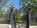 Beautiful cast-iron gates with lanterns and a lattice with decorations at the entrance to the Summer Garden of the city of Royalty Free Stock Photo