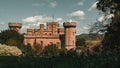 Beautiful Castle of Eastnor surrounded by trees with mountains and the blue sky in the bakcground Royalty Free Stock Photo