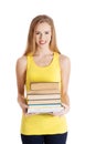 Beautiful casual caucasian woman student holding stack of books.