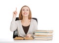 Beautiful casual student woman sitting by stack of books and poi Royalty Free Stock Photo