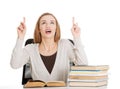 Beautiful casual student woman sitting by stack of books and poi Royalty Free Stock Photo