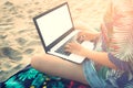 Beautiful casual woman with a laptop on the beach Royalty Free Stock Photo