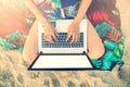 Beautiful casual woman with a laptop on the beach Royalty Free Stock Photo