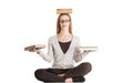 Beautiful casual woman sitting with books on palms and head, doing yoga. Royalty Free Stock Photo