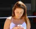 Beautiful casual woman texting on her cell phone Royalty Free Stock Photo