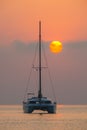 Beautiful catamaran sailing on the background of the sea sunrise Royalty Free Stock Photo