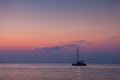 Beautiful catamaran sailing on the background of the sea sunrise Royalty Free Stock Photo