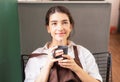 Beautiful caucasian barista woman sitting blankly and enjoys hot black coffee in coffee break at coffee shop Royalty Free Stock Photo