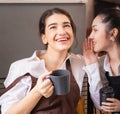 Beautiful caucasian barista women feel happy after hearing message from another barista in coffee break at coffee shop, focusing Royalty Free Stock Photo