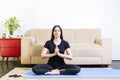 Beautiful caucasian brunette woman in black clothes on blue yoga