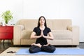 Beautiful caucasian brunette woman in black clothes on blue yoga Royalty Free Stock Photo