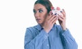 Beautiful Caucasian brunette woman listens to the sound of coinsin a piggy bank and dreams. Royalty Free Stock Photo