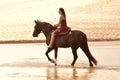 Pretty woman riding her black horse