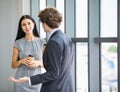 Beautiful caucasian business woman laugh on free talk with smiling corporate colleague and enjoy relaxing with coffee drink at Royalty Free Stock Photo