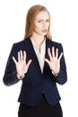 Beautiful caucasian business woman is showing refusing, rejecting gesture.