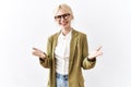 Beautiful caucasian business woman standing over isolated background smiling cheerful offering hands giving assistance and Royalty Free Stock Photo