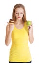 Beautiful caucasian casual woman with doughnuts and apple. Royalty Free Stock Photo