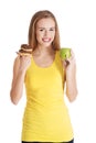 Beautiful caucasian casual woman with doughnuts and apple. Royalty Free Stock Photo