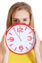 Beautiful caucasian casual woman holding red clock. Royalty Free Stock Photo