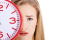 Beautiful caucasian casual woman holding red clock. Royalty Free Stock Photo