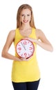 Beautiful caucasian casual woman holding red clock. Royalty Free Stock Photo