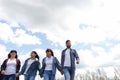 Beautiful Caucasian family against the clouds