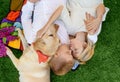Beautiful caucasian family man and woman lying with white Labrador dog Royalty Free Stock Photo