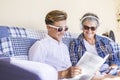 Beautiful caucasian family with teenager and grandmother studying together before the school begin in september. using music and