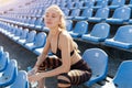 Beautiful Caucasian girl athlete holds in her hands a water in a plastic bottle