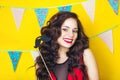 Beautiful caucasian girl blowing candles on her cake. Celebration and party. Having fun. Young pretty woman in red dress and birth Royalty Free Stock Photo