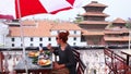 Beautiful Caucasian girl eating breakfast, lunch at rooftop, Kathmandu, Nepal,