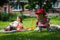 Portrait of two girls in the park at a picnic. Royalty Free Stock Photo